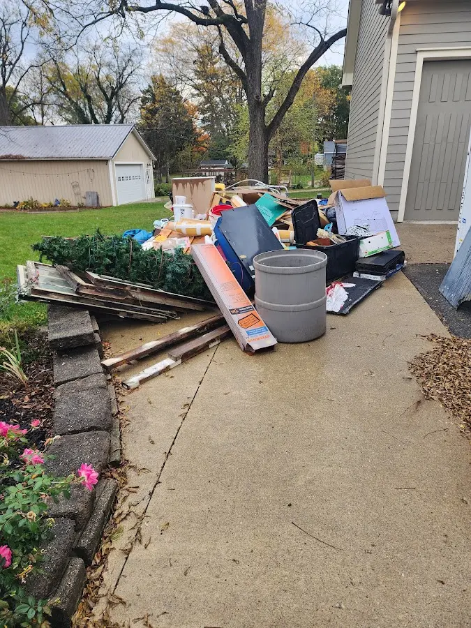 Dumpster being loaded with debris for 10 Yard Dumpster Rental in Inver Grove Heights